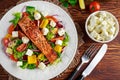 Fried Salmon steak with fresh vegetables salad, feta cheese. concept healthy food. Royalty Free Stock Photo