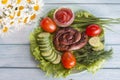 Fried sausage with fresh vegetables and herbs Royalty Free Stock Photo