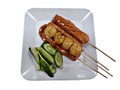 sausage a grill on a stick in sauce eat with cucumber, traditional food in Thailand on white background Royalty Free Stock Photo