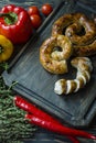 Fried sausage with herbs and spices, wooden background. Ring of baked homemade sausage. Served on a wooden board with greens and Royalty Free Stock Photo