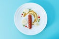 Fried sausage with mashed potatoes, mustard, green peas and drops of ketchup Royalty Free Stock Photo