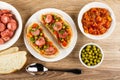 Fried sausage in plate, bread, sandwiches with sausage, vegetable stew and green peas in plate, bowl with vegetable stew, bowl Royalty Free Stock Photo