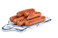 Fried sausages on a ceramic serving Board, white isolated background, close-up, horizontal view Royalty Free Stock Photo