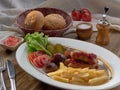 Fried sausages with French fries, salad and mushrooms Royalty Free Stock Photo