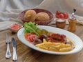 Fried sausages with French fries, salad and mushrooms Royalty Free Stock Photo