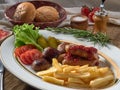 Fried sausages with French fries, salad and mushrooms Royalty Free Stock Photo