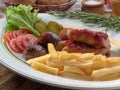 Fried sausages with French fries, salad and mushrooms Royalty Free Stock Photo