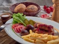 Fried sausages with French fries, salad and mushrooms Royalty Free Stock Photo