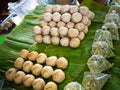 Fried sausages and fried meatballs from pork. on banana leaf ready for sale in the fresh markets, Thailand street food. Royalty Free Stock Photo