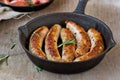 Fried sausages on a frying pan