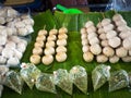 Fried sausages and fried meatballs from pork. on banana leaf ready for sale in the fresh markets, Thailand street food Royalty Free Stock Photo