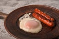 Fried sausages on a plate with scrambled eggs close-up and copy space. Boiled sausages and fried eggs for breakfast in a plate Royalty Free Stock Photo