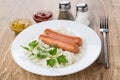 Fried sausages with rice, mustard and ketchup, salt, pepper