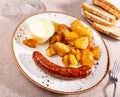 Fried sausages served with potatoes and alioli sauce Royalty Free Stock Photo