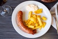 Fried sausages served with potatoes and alioli sauce Royalty Free Stock Photo