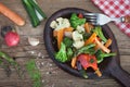 Fried season vegetables on wooden plate