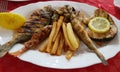 Fried several different river fish, with potatoes on a white plate Royalty Free Stock Photo