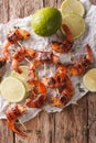 Fried shrimp with bacon, spices and lime close up. Vertical top