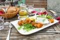 Fried shrimps, garlic dip, rucola salad, wine, bread on wooden table Royalty Free Stock Photo