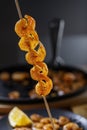 Fried shrimps and lemon on a wooden stick Royalty Free Stock Photo
