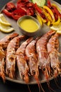 Fried shrimps on plate with fresh vegetables and lemon slice. Seafood background Royalty Free Stock Photo