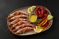 Fried shrimps on plate with fresh vegetables and lemon slice. Seafood background Royalty Free Stock Photo