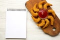 Fried shrimps tempura with sauce on rustic wooden board. Blank notepad. White wooden background. Top view, overhead Royalty Free Stock Photo