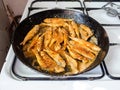 Fried small Black Sea red mullet fishes on stove Royalty Free Stock Photo