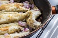 Fried smelt fish lies on a frying pan