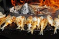 Fried smelts on barbecue fire bowl