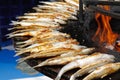 Fried smelts on barbecue fire bowl