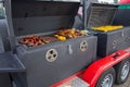 Fried smoked sausages, fried chicken wings, peppers and paprika, toasted corn on fire, street food, mobile barbecue Royalty Free Stock Photo