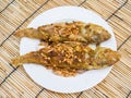 Fried snapper fish with garlic on the plate