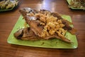 Fried snapper served on a green plate