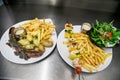 Fried sosage with French fries and salad Royalty Free Stock Photo