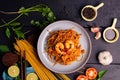 Fried Spaghetti or Fried Noodles Tomato sauce and prawns on a blue plate On a black wooden table top, top view Royalty Free Stock Photo