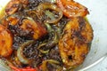 Fried Spanish mackerels fish cooked with black soy sauce.