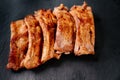 fried with spices pork ribs in a glass baking sheet on a stone black background Royalty Free Stock Photo