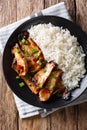 Fried spicy King Brown Mushroom with rice close-up on a plate. V