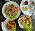 Fried spring rolls, fried sausages and glass noodle salad with minced pork on the table. Royalty Free Stock Photo