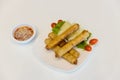 Fried spring rolls with red and white sauces. Deep fried spring roll with sauce on white plate. Crispy spring rolls on dish with v Royalty Free Stock Photo