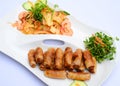Fried spring rolls with shrimp salad and vegetables on white dis Royalty Free Stock Photo