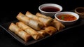 Fried spring rolls with sweet and sour sauce on black background.