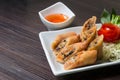 Fried Spring rolls on white dish in the kitchen and wooden table Royalty Free Stock Photo