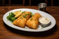 Fried spring rolls on a white plate with sour cream and lemon, A delicious plate of two golden battered fish fillets served, AI Royalty Free Stock Photo