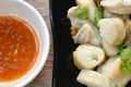 Fried squid egg or gonad with chop fresh cabbage on plate dipping spicy and sour sauce