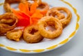 Fried squid rings in batter on a white plate. Restaurant. Royalty Free Stock Photo