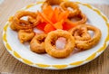 Fried squid rings in batter on a white plate. Restaurant. Royalty Free Stock Photo