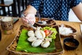 Fried squids in wood plate.Steamed squid fried with salty sauce Thai food. Royalty Free Stock Photo