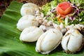 Fried squids in wood plate.Steamed squid fried with salty sauce Thai food. Royalty Free Stock Photo